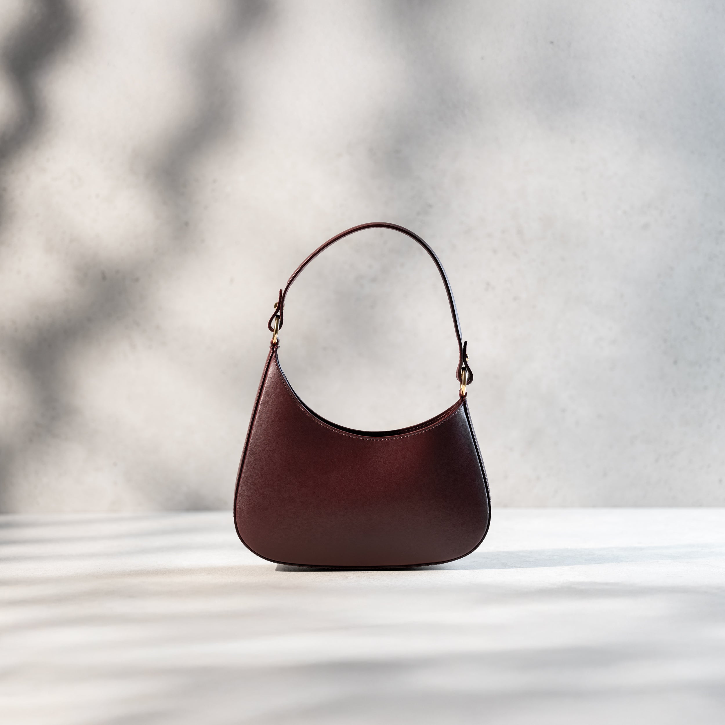 sac à main forme hobo demi lune asymétrique pour femme en cuir lisse bordeaux 
